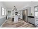 Open kitchen with stainless steel appliances, an island, and elegant gray cabinets at 4126 S Gerrard Dr, Indianapolis, IN 46221
