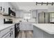 Well-lit kitchen boasts stainless steel appliances, white subway tile, and sleek gray cabinetry at 4126 S Gerrard Dr, Indianapolis, IN 46221