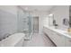 Bright bathroom with a freestanding tub, glass shower, and double vanity with modern finishes at 435 Virginia Ave # 101, Indianapolis, IN 46203