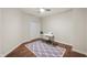 Minimalist bedroom setup with desk, area rug, ceiling fan, and hardwood floors at 435 Virginia Ave # 101, Indianapolis, IN 46203