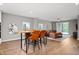 Open-concept dining area with stylish seating and wood grain floors throughout at 435 Virginia Ave # 101, Indianapolis, IN 46203