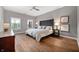 Serene main bedroom featuring natural light, a ceiling fan, and wood grain floors at 435 Virginia Ave # 101, Indianapolis, IN 46203