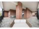 Brick outdoor patio with covered seating area, outdoor fireplace, and stylish neutral furnishings at 435 Virginia Ave # 101, Indianapolis, IN 46203