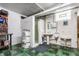 Basement bathroom with minimalist fixtures, including a sink, toilet, urinal, and a stall shower at 5165 E Pleasant Run Pkwy S Dr, Indianapolis, IN 46219