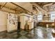 Functional basement area equipped with laundry facilities, refrigerator, and ample storage at 5165 E Pleasant Run Pkwy S Dr, Indianapolis, IN 46219