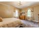 Inviting bedroom featuring neutral walls, plush carpet, and bright windows with decorative curtains at 5165 E Pleasant Run Pkwy S Dr, Indianapolis, IN 46219