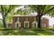 Charming brick home with meticulously landscaped front yard and mature trees at 5165 E Pleasant Run Pkwy S Dr, Indianapolis, IN 46219