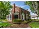 An elegant brick house featuring a screened porch and lush backyard garden at 5165 E Pleasant Run Pkwy S Dr, Indianapolis, IN 46219