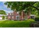 Classic brick home with lush greenery, a spacious lawn, and a welcoming outdoor setting at 5165 E Pleasant Run Pkwy S Dr, Indianapolis, IN 46219