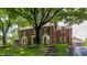 Beautiful brick home with mature landscaping and a private driveway at 5165 E Pleasant Run Pkwy S Dr, Indianapolis, IN 46219
