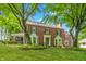 Lovely brick home with lush landscaping and a screened in porch, complemented by copper roofing accents at 5165 E Pleasant Run Pkwy S Dr, Indianapolis, IN 46219