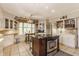 Traditional kitchen with central island, stainless appliances, custom cabinets, and tile floor at 5165 E Pleasant Run Pkwy S Dr, Indianapolis, IN 46219