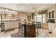 Well-lit kitchen with stainless steel appliances, center island, and ample cabinet space at 5165 E Pleasant Run Pkwy S Dr, Indianapolis, IN 46219