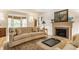Cozy living room with hardwood floors, tufted sofa, fireplace, and custom mantle at 5165 E Pleasant Run Pkwy S Dr, Indianapolis, IN 46219