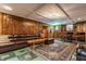 A cozy basement rec room with wood paneling, coffered ceilings and bar seating at 5165 E Pleasant Run Pkwy S Dr, Indianapolis, IN 46219