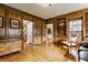 Sophisticated wood-paneled living room with custom built-ins and hardwood floors at 5165 E Pleasant Run Pkwy S Dr, Indianapolis, IN 46219
