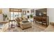 Inviting living room featuring a large sectional, wooden media center, and natural light at 5165 E Pleasant Run Pkwy S Dr, Indianapolis, IN 46219