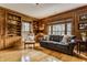 Classic living room with wood paneled walls, bookshelves and a comfortable sitting area at 5165 E Pleasant Run Pkwy S Dr, Indianapolis, IN 46219