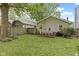 Spacious backyard featuring a wood fence, well-maintained lawn, and outdoor dining area at 5259 Broadway St, Indianapolis, IN 46220