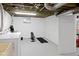 Finished basement with washer and dryer, gym equipment, and freshly painted floors and walls at 5259 Broadway St, Indianapolis, IN 46220