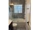 Updated bathroom with tiled floor, shower with glass door, and a modern vanity at 5259 Broadway St, Indianapolis, IN 46220