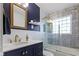 Elegant bathroom featuring stylish vanity, and shower with navy and white tile at 5259 Broadway St, Indianapolis, IN 46220