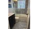 Stylishly updated bathroom featuring modern tile, a glass-enclosed shower, and a sleek vanity at 5259 Broadway St, Indianapolis, IN 46220