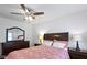 Inviting bedroom featuring a patterned bedspread, dark wood furniture, and soft lighting for a restful retreat at 5259 Broadway St, Indianapolis, IN 46220
