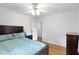 Spacious bedroom with hardwood floors, large bed, and ample natural light at 5259 Broadway St, Indianapolis, IN 46220