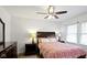 Comfortable bedroom with a ceiling fan, large window, and traditional furnishings, creating a cozy atmosphere at 5259 Broadway St, Indianapolis, IN 46220