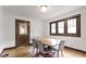 Elegant dining room with hardwood floors, a vintage door, and natural light at 5259 Broadway St, Indianapolis, IN 46220