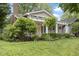Beautiful home featuring a charming front porch, landscaped yard, and mature trees at 5259 Broadway St, Indianapolis, IN 46220