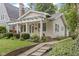 Charming home featuring a welcoming front porch with a pathway leading to the entrance at 5259 Broadway St, Indianapolis, IN 46220