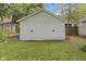 The property features a detached white wooden garage with double doors and a well-maintained lawn at 5259 Broadway St, Indianapolis, IN 46220