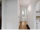 Hallway leading to a bathroom with decorative tile and updated finishes at 5259 Broadway St, Indianapolis, IN 46220