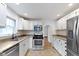 Updated kitchen with stainless steel appliances, granite countertops, and ample cabinet space at 5259 Broadway St, Indianapolis, IN 46220