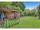 Serene backyard featuring green grass and storage area with privacy fence at 5333 Ralston Ave, Indianapolis, IN 46220