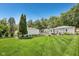 Spacious backyard with green lawn, manicured landscaping and white fence at 5333 Ralston Ave, Indianapolis, IN 46220