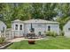 Private backyard features a patio area with seating and lush green lawn at 5333 Ralston Ave, Indianapolis, IN 46220