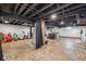 Unfinished basement space with laundry, exercise equipment, and storage options at 5333 Ralston Ave, Indianapolis, IN 46220