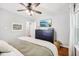 Bright bedroom featuring a black dresser, ceiling fan, and natural light from the window at 5333 Ralston Ave, Indianapolis, IN 46220