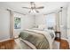 Comfortable bedroom features a ceiling fan, hardwood floors, and two windows for natural light at 5333 Ralston Ave, Indianapolis, IN 46220