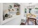 Open dining nook complemented by a built-in bar and natural light from the adjacent windows at 5333 Ralston Ave, Indianapolis, IN 46220