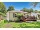 Side view of a charming house with a wooden deck, a well-maintained lawn, and a white picket fence at 5333 Ralston Ave, Indianapolis, IN 46220