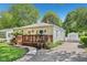 Quaint home with a well-kept lawn, wooden deck, and a detached garage visible down the driveway at 5333 Ralston Ave, Indianapolis, IN 46220