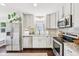 Modern kitchen with stainless steel appliances, granite countertops, and dark hardwood floors at 5333 Ralston Ave, Indianapolis, IN 46220