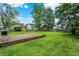 Expansive backyard with large deck, mature trees, a storage shed, and lots of green space at 5369 Red River Ct, Indianapolis, IN 46221