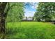 Wide open backyard with a large tree and wooden fence at 5369 Red River Ct, Indianapolis, IN 46221