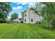 Spacious backyard featuring a large lawn, wooden deck, and mature trees for shade and privacy at 5369 Red River Ct, Indianapolis, IN 46221