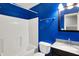Bathroom with white shower-tub, granite countertop sink and vibrant blue painted walls at 5369 Red River Ct, Indianapolis, IN 46221